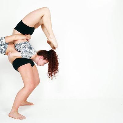 Close-up of a controlled yoga movement showing muscle engagement.